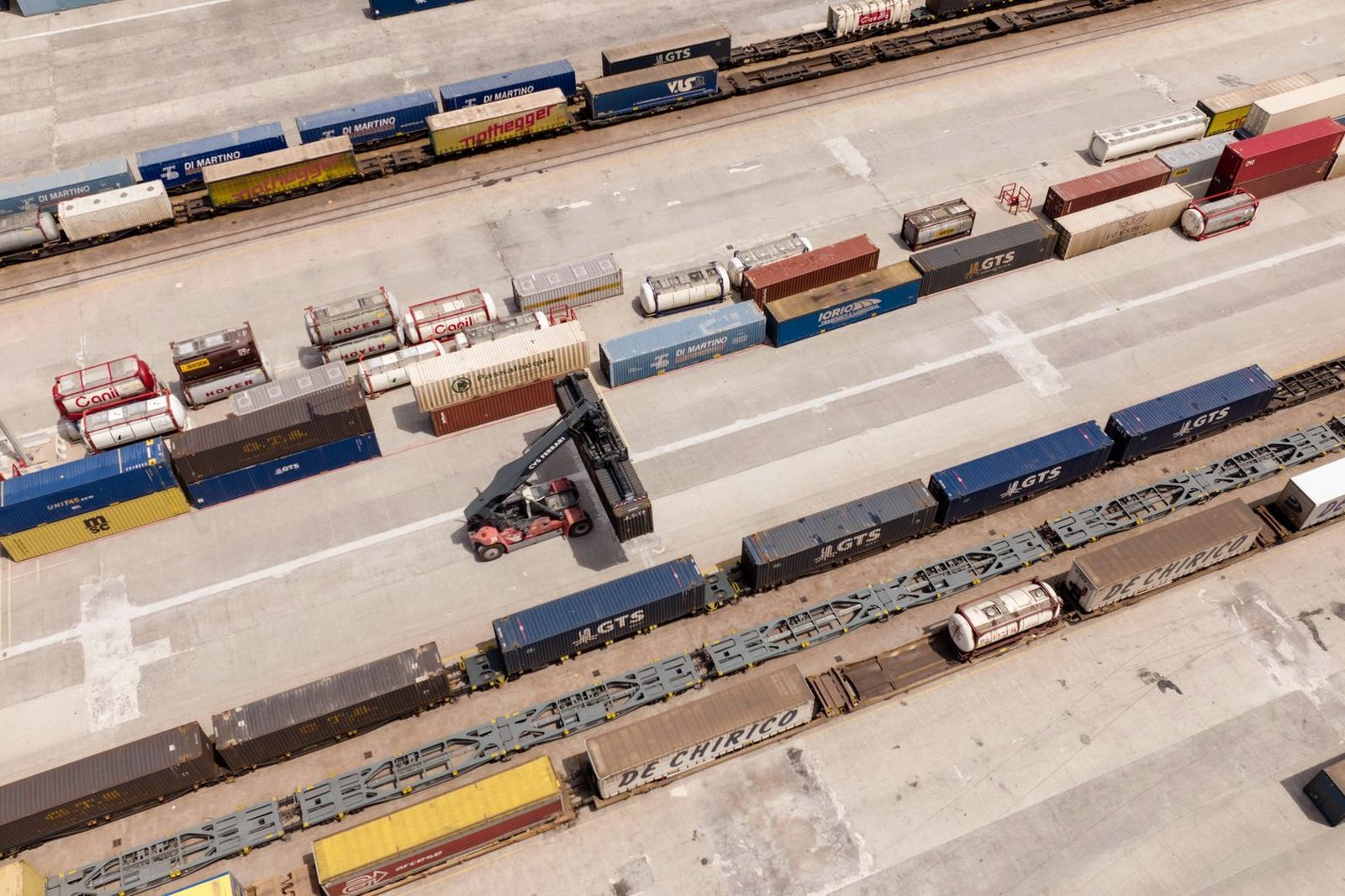 Containers stacked under gantry cranes