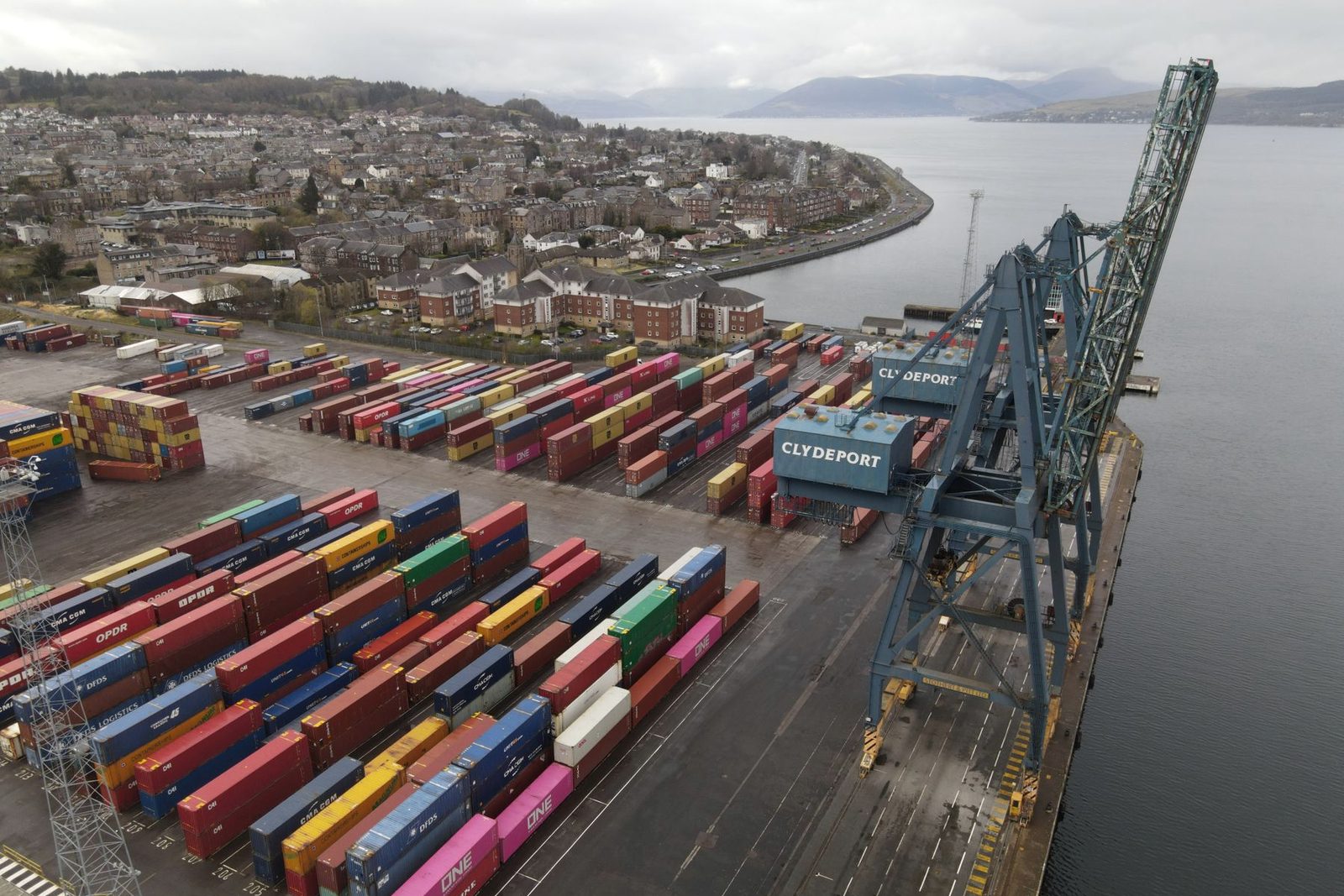 Containers stacked under gantry cranes