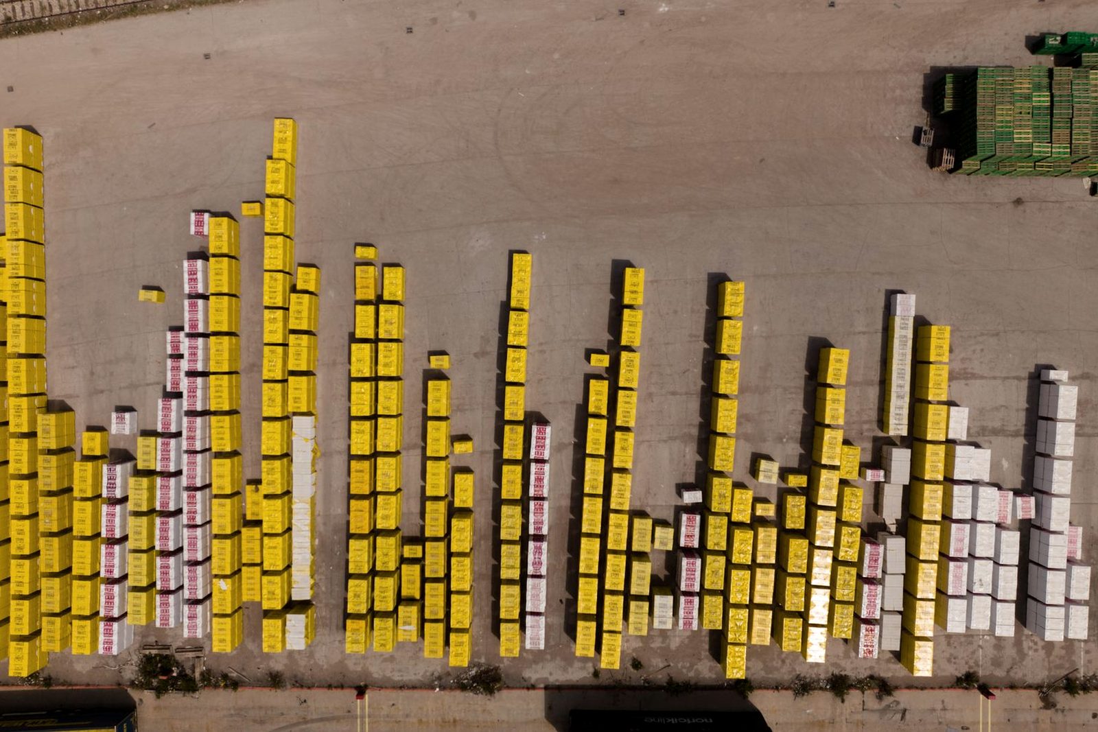 Containers stacked under gantry cranes
