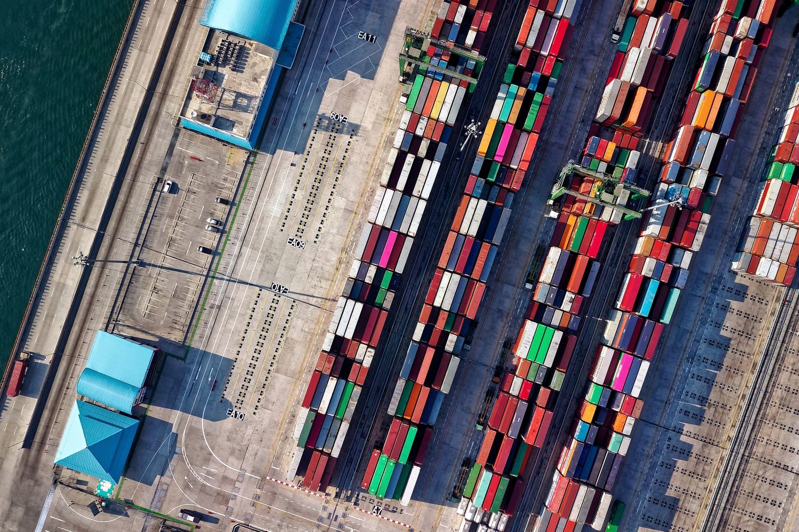 Containers stacked under gantry cranes