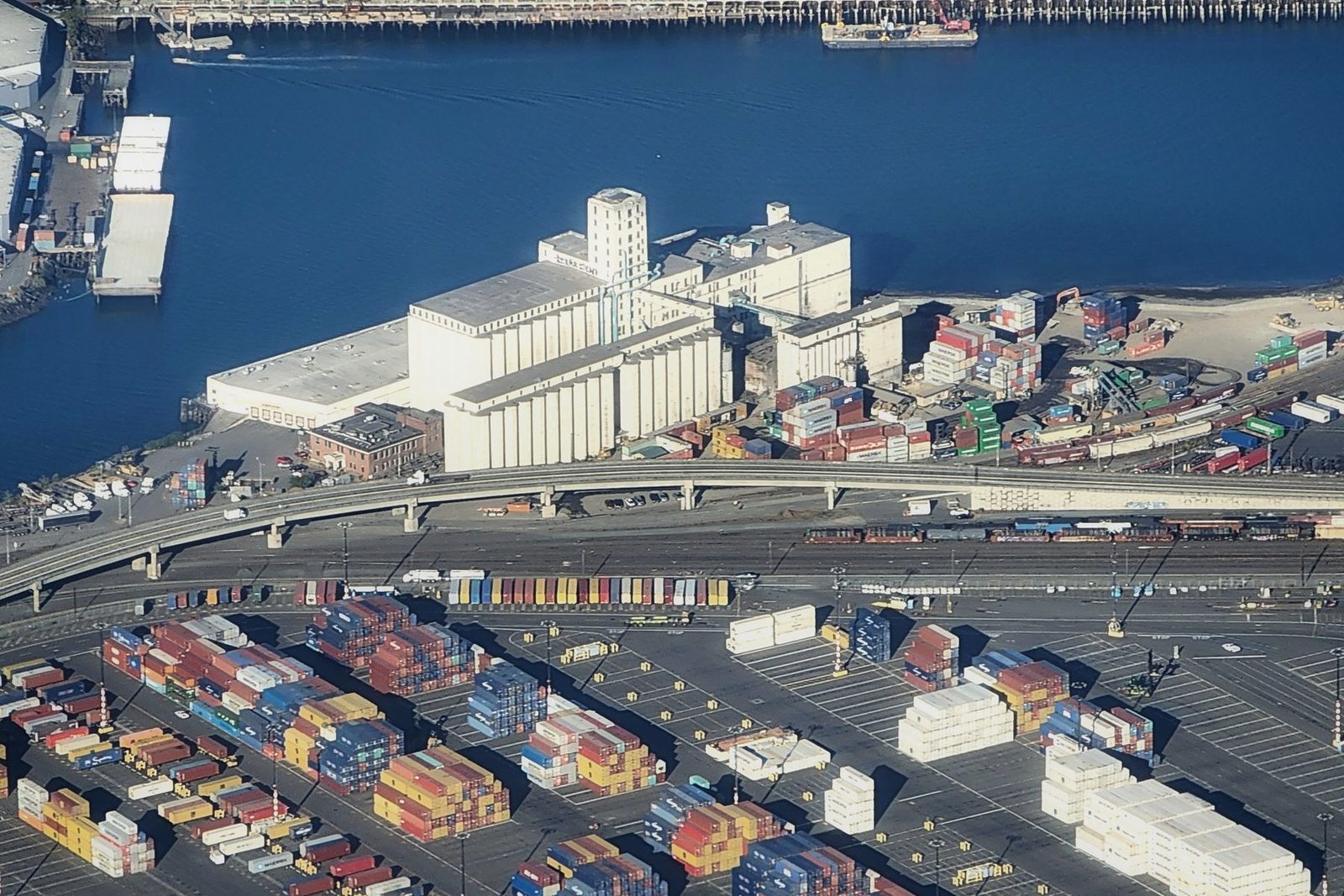 Containers stacked under gantry cranes