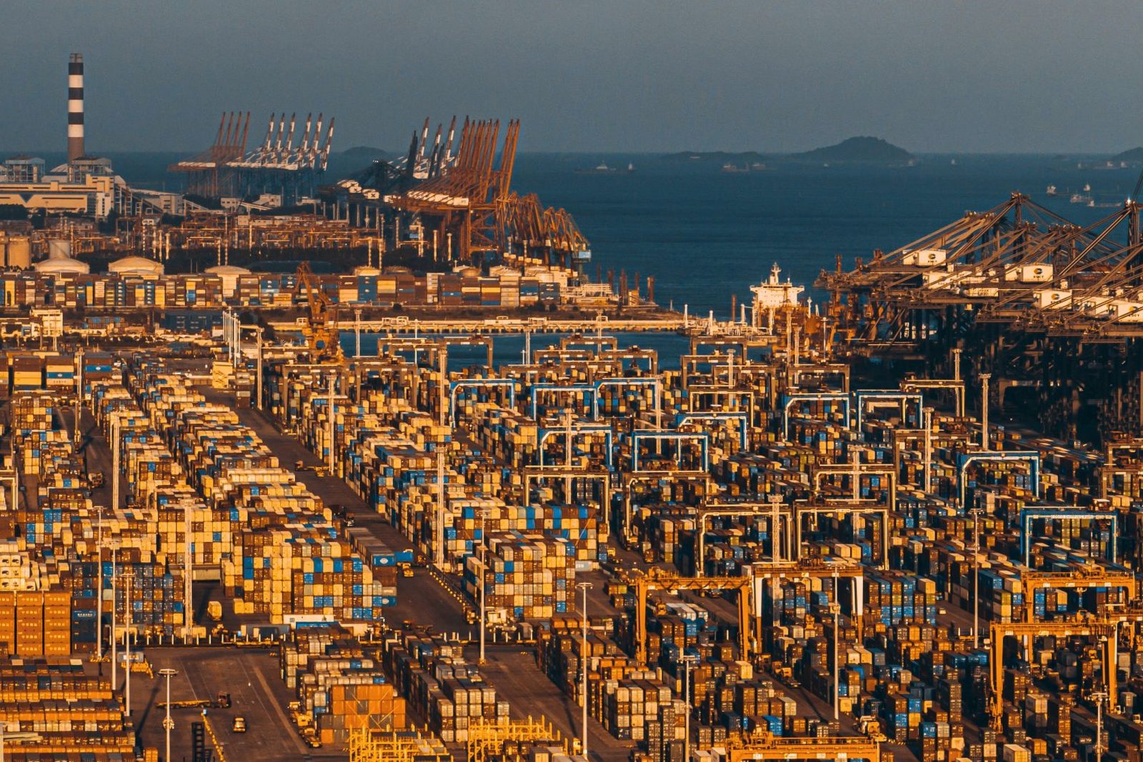Containers stacked under gantry cranes