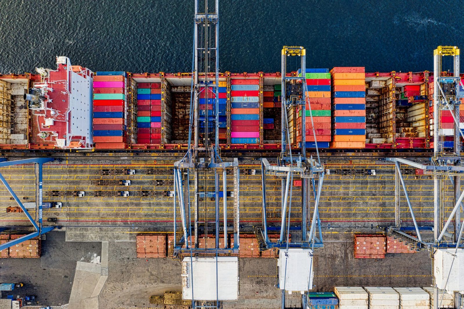 Containers stacked under gantry cranes