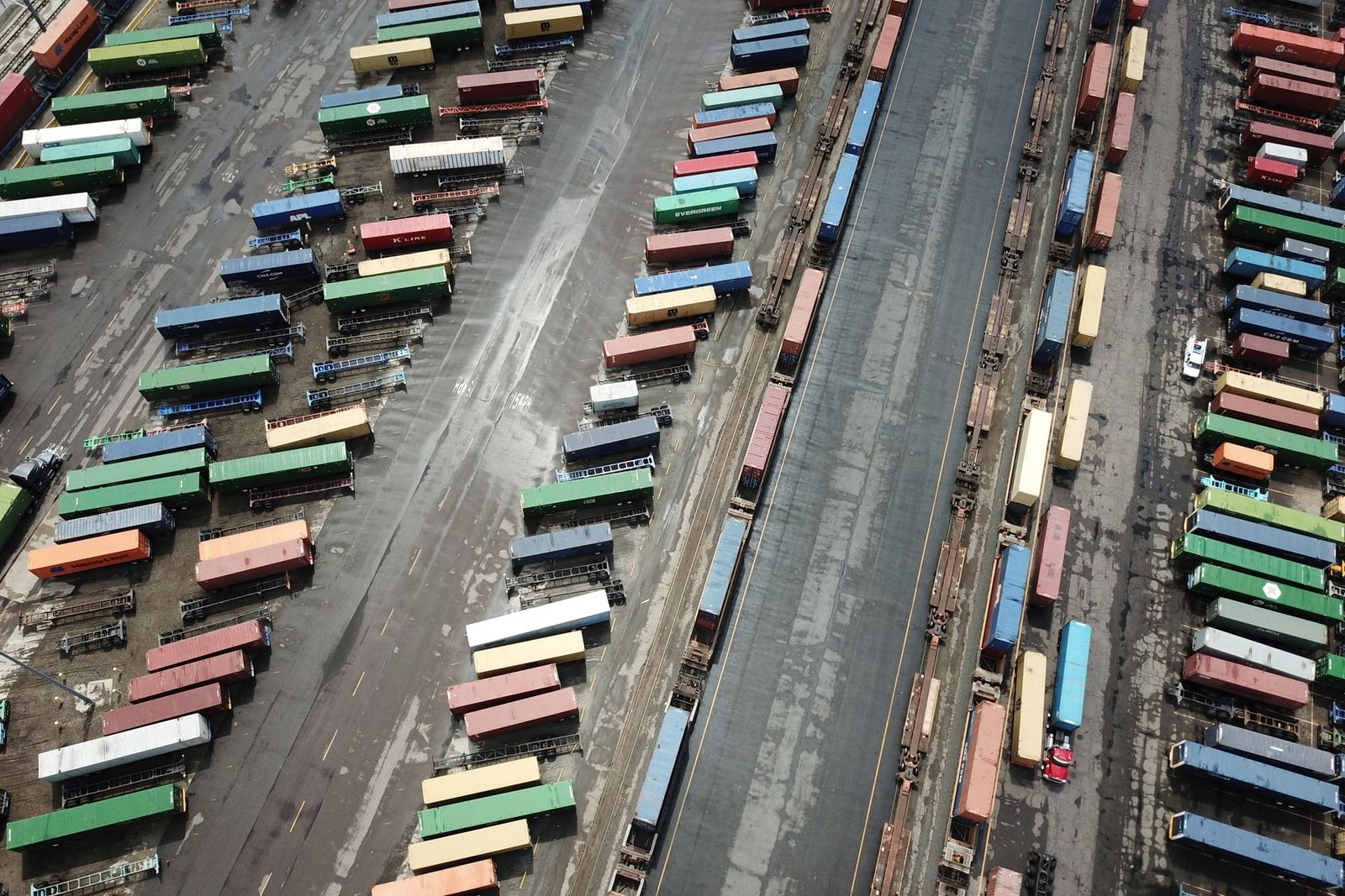 Containers stacked under gantry cranes